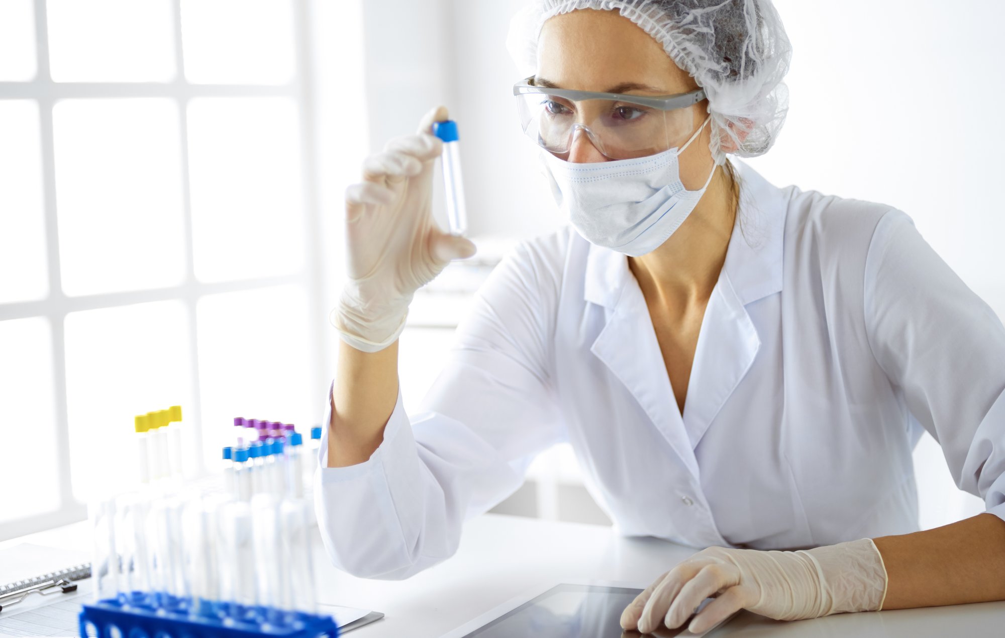 professional-female-scientist-protective-eyeglasses-researching-tube-with-reagents-laboratory-concepts-medicine-research